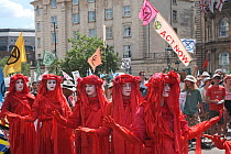 The Red Brigade performance artists on Extinction Rebellion climate change protest march. Bristol, England, UK. 16 July 2019.
