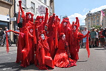 The Red Brigade performance artists at Extinction Rebellion climate change protest. Bristol, England, UK. 16 July 2019.