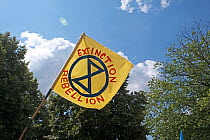 Extinction Rebellion flag flying during climate change protest. Bristol, England, UK. 16 July 2019.