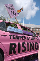 &#39;Tell the truth&#39; placard and pink car with &#39;Temperature&#39;s rising&#39; message. Extinction Rebellion protest. Bristol, England, UK. 16 July 2019.