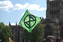Extinction Rebellion logo on flag. Climate change protest march, Bristol, England, UK. 16 July 2019.