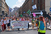 Extinction Rebellion climate change protesters marching through city centre. Baldwin Street, Bristol, England, UK. 16 July 2019.