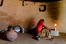 Woman preparing fire in her traditional house in a small village in Rajasthan, India. October 2018.