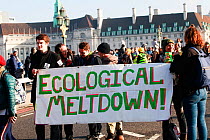 Protestors holding &#39;Ecological meltdown!&#39; banner at Extinction Rebellion climate change demonstration. London, England, UK. 17 November 2019.