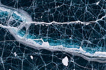 Black ice with cracks on Lake Baikal, aerial shot. Photographed for The Freshwater Project extended. Near Khuzhir, Olchon Island, Irkutsk Oblast and Buryat Republic, Siberia, Russia. February 2019.