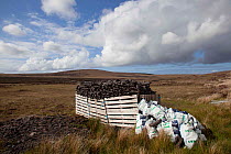 Hand dug peat in stacks, collected by hand, for domestic use. North Uist, Scotland, UK, June.