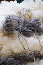 White and grey spun wool in woollen mill. Uist, Outer Hebrides, Scotland, July.