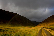 Rainbow over mountains, now part of ecological restoration project. Alladale Estate, Scotland, UK, October.