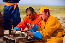 Monks chanting sutras in mountain worshipping ceremony. Great Gobi B Strictly Protected Area, Mongolia. 2018.