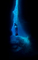 Taiwanese diver exploring a shallow cave, Green Island, Taiwan.