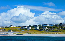Coastal village under cloudy sky. Inisheer, Aran Islands, County Galway, Republic of Ireland. May 2011.