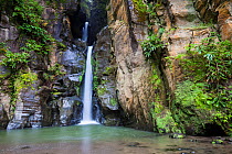 Salto do Cabrito waterfall flowing over rockface. Lombadas Valley Nature Reserve, Sao Miguel Island, Azores, Portugal.
