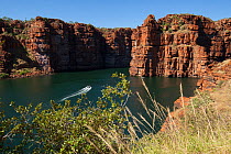 Zodiac boat with tourists approaching site of waterfalls of King George River, during dry season. Koolama Bay, The Kimberley, Western Australia. July 2015.