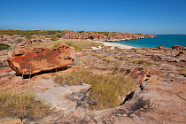 Rocky coastline with view to location of cave with Aboriginal rock art. Wary Bay, Bigge Island, Bonaparte Archipelago, The Kimberley, Western Australia. 2015.