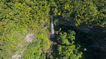 Drone shot flying along a river and revealing the top of Middleham Falls, Morne Trois Pitons National Park, Dominica, 2019.