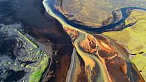 Aerial shot of a confluence of three tributaries flowing over black sand at the mouth of the Affall River, Landeyjar area, Southern Iceland, August 2018.