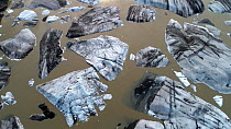 Aerial view of large pieces of calved ice in a meltlake beneath Hoffellsjokull, an outlet glacier of the Vatnajokull ice cap, Iceland, August 2018