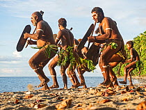 Men performing traditional dance on beach. Savo Island, Solomon Islands.