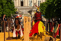 Men dressed as medieval knights jousting on horseback. Ommegang religious and historical pageant procession, Brussels, Belgium. June 2019.