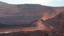 Large earth moving machinery driving in an open-cast mine, Rondonia, Brazil, 2019.