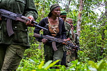 Portrait of female ecoguard / ranger, with colleagues in Salonga National Park, Democratic Republic of Congo. May 2017. There are 16 women who work as Ecoguards protecting the largely untouched 8.9 mi...