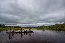 Ecoguards / Rangers crossing river in dugout canoe, Salonga National Park. Democratic Republic of Congo. May 2017.