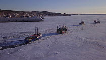 Fishing boats breaking a route through ice so they can leave to fish, the harbour remained frozen unusually late, Lewisporte Bay, Newfoundland and Labrador, Canada, April 2018.