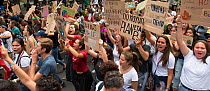 Young protestors with placards chanting during &#39;Fridays for the Future&#39; climate change protest. Paseo de la Reforma Avenue, Mexico City, Mexico. September 2019.