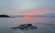 Sunrise over coastal rocks and Atlantic ocean, Acadia National Park, Maine, USA. November 2018.