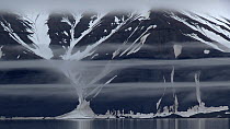 Tracking shot of fog lines and fjord coast, Sabine Land, East Spitsbergen, Svalbard, Norway, 2016.