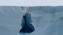 Close-up shot tracking down a meltwater waterfall emerging from a glacier, Brasvellbreen Glacier, Magdalena Fjord, Svalbard, Norway, 2016.
