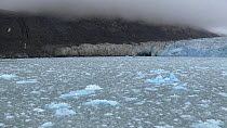 Tracking shot of glacier and mountains in fog, Magdalena Fjord, Svalbard, Norway, 2016.