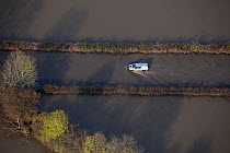 Aerial view of Environment Agency vehicle driving through floodwater from River Don, Fishlake, South Yorkshire, UK. November 2019.