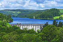 Lake Vyrnwy reservoir with water overflowing dam after heavy rainfall. Llanwddyn, Montgomeryshire, Powys, Wales, UK. June 2019.