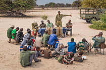 A meeting at a farming co-operative run by members of Cheetah Conservation Botswana (CCB) and the Department of Wildlife and National Parks. A representative of DWNP explaining the differences between...