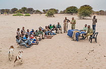 A meeting at a farming co-operative run by members of Cheetah Conservation Botswana (CCB) and the Department of Wildlife and National Parks. A representative of DWNP explaining the differences between...