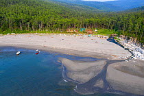 Beach and river estuary, boreal forest in background, aerial view. Camp on beach, gathering to watch Bowhead whale (Balaena mysticetus) congregation. Vrangel Bay, Primorsky Krai, Russia. August 2019.