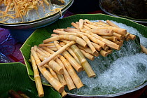 Bamboo (Bambusidae) shoots prepared for sale, on market stall. Bangkok, Thailand.