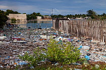 Irregular housing constructed over trash in the coastal lagoon, Ria Celestun, Yucatan Peninsula, Mexico, January