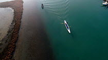 Aerial tracking shot of two gondolier's propelling a gondola in Venice Lagoon, Venice, Italy, October 2015.