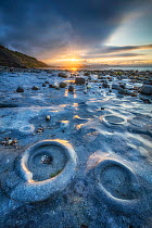 Ammonite Graveyard at sunrise, Monmouth Beach, Lyme Regis, Jurassic Coast World Heritage Site, Dorset, England, UK