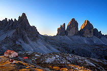 Mountain refuge Dreizinnenhutte / Rifugio Antonio Locatelli at sunrise and the Drei Zinnen / Tre Cime di Lavaredo in the Dolomites, South Tyrol, Italy, October 2019