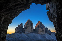Tre Cime di Lavaredo / Drei Zinnen, three distinctive mountain peaks in the Sexten Dolomites seen from WW1 cave shelter, South Tyrol, Italy, October 2019