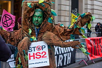 A protestor campaigning against HS2 High speed rail, dressed as an ancient tree' outside the Science Musuem London.February, 2020.