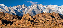 Weathered granite boulders and snow-covered Sierra Nevada Mountains. Mt. Whitney, tallest mountain in the contiguous United States with an elevation of 14,505 feet. is just left of center. Alabama Hil...