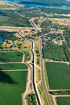 Border wall through agricultural land in Rio Grande Valley, aerial view. Mission, Hidalgo County, Texas, USA. July 2019.