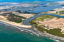 Aerial view of Rio Grande flowing into Gulf of Mexico, the border between Cameron County, Texas, USA and Tamaulipas, Mexico. July 2019.
