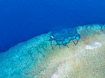 Aerial view of a dive site on the southern end of the reef surrounding the island of Yap, Micronesia. One dive boat is anchored at Yap Cavern's, a famous site for scuba divers.