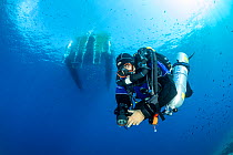 Rebreather diver or technical diver doing decompression stop under the boat, Vis Island, Croatia, Adriatic Sea, Mediterranean