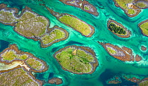 Aerial view of sporadically inhabited islands, islets and skerries in a wide coastal plain. Husvaer, Helgeland Archipelago, Norway. July.